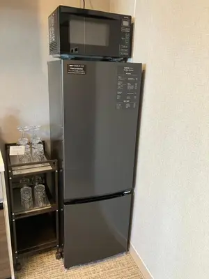 a refrigerator with a microwave on top of it at ENT TERRACE AKIHABARA in Tokyo