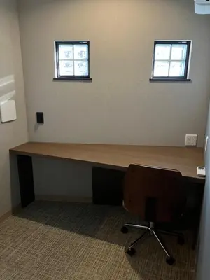 a desk in an office with a chair and two windows at ENT TERRACE AKIHABARA in Tokyo