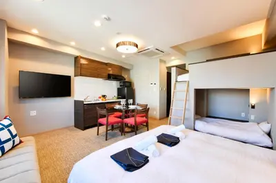 a hotel room with two beds and a desk at ENT TERRACE AKIHABARA in Tokyo