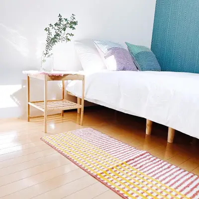 a bedroom with a bed with a table and a rug at \u5c0f\u6625\u65e5\u548c_SOLAMO_\u5fae\u751c\u9928 in Tokyo