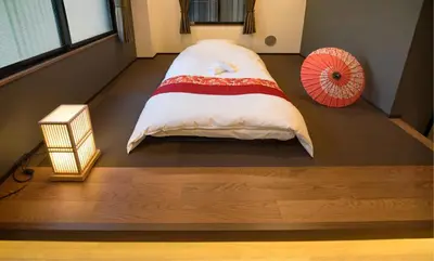 a bed in a room with a red umbrella at ohayo\u62bc\u4e0a in Tokyo