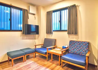 a waiting room with two chairs and a tv at ohayo\u62bc\u4e0a in Tokyo