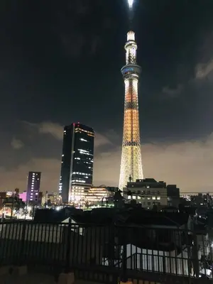 a view of the eiffel tower at night at ohayo\u62bc\u4e0a in Tokyo
