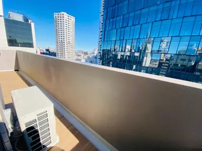 a balcony with a view of a city skyline at FLOWER TERRACE Higashi Shinjuku in Tokyo