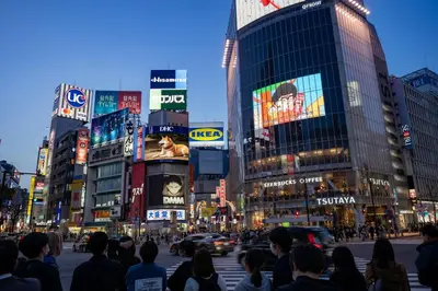 a crowd of people crossing the street in a busy city at NEW!Shibuya Prime Unit, near Shibuya Sky & Hachiko in Tokyo