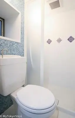 a white bathroom with a toilet and a sink at Skytree Easy Access Tokyo Apartment - Bell Flat Inn #1 in Tokyo