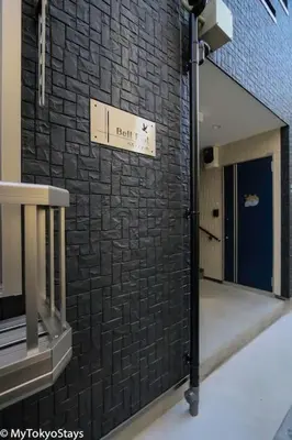 a room with a black brick wall and a door at Skytree Easy Access Tokyo Apartment - Bell Flat Inn #1 in Tokyo