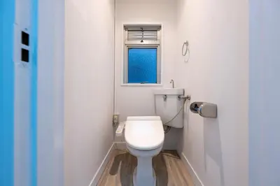 a white toilet in a bathroom with a window at LUANAHOTEL IN YOTSUYA in Tokyo