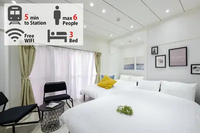 a bedroom with two beds and a sign that says first wifi at LUANAHOTEL IN YOTSUYA in Tokyo