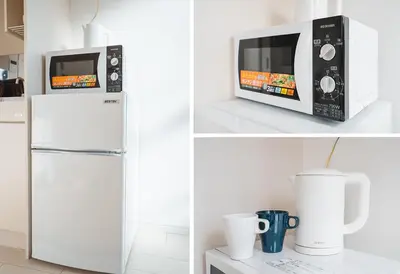 a microwave oven sitting on top of a refrigerator at Ustay Nippori in Tokyo