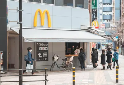 a group of people standing outside of a mcdonalds restaurant at Ustay Nippori in Tokyo