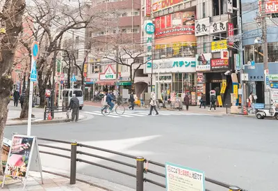 a busy city street with people crossing the street at Ustay Nippori in Tokyo