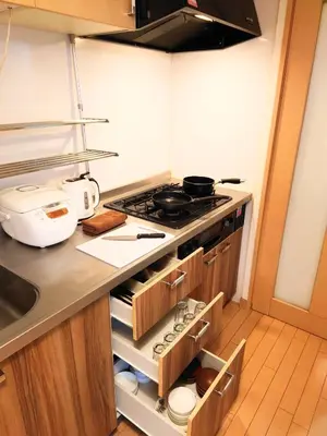 a kitchen with a stove and a sink at kaneshiro guest house in Tokyo