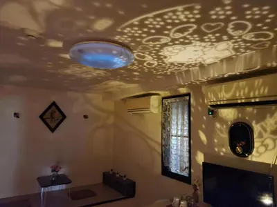 a bathroom with a ceiling with a blue light on it at kaneshiro guest house in Tokyo