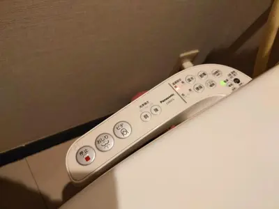 a remote control sticking out of a box at kaneshiro guest house in Tokyo