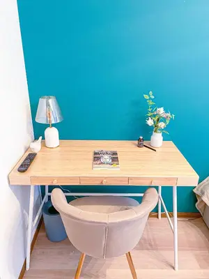 a wooden desk with a lamp and a chair at Al Di La \u56db\u8c37 in Tokyo