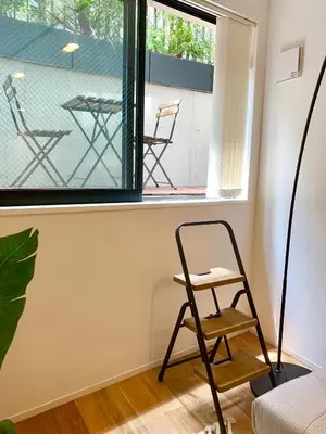 a chair sitting in a room with a window at Ken's Place四谷 in Tokyo