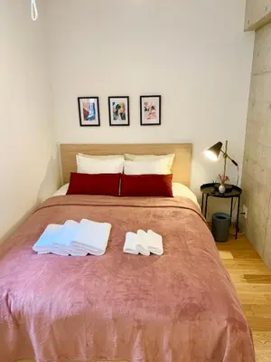 a bedroom with a large bed with two towels on it at Ken's Place四谷 in Tokyo