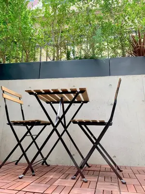 a picnic table and two chairs on a patio at Ken's Place四谷 in Tokyo