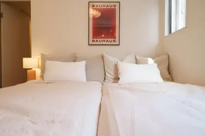 two white beds sitting next to each other in a room at Space Roppongi in Tokyo