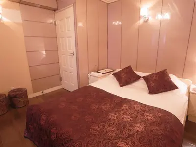 a bedroom with a large bed with two pillows on it at SKYROAD Adult Only in Tokyo