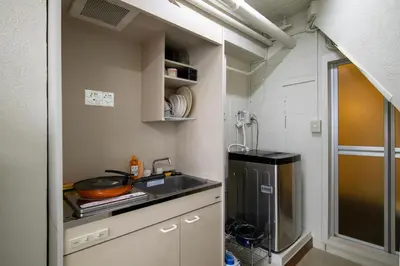 a small kitchen with a sink and a stove at \u6d45\u8349classy\u30cf\u30a6\u30b9 in Tokyo