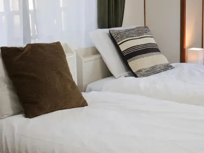 two white beds with pillows on them in a room at Amber Iidabashi - Vacation STAY 89899v in Tokyo