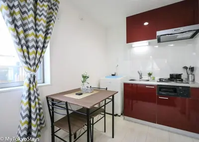 a kitchen with a small table and a counter top at Skytree Easy Access Studio Apt Bell Flat Inn #3 in Tokyo