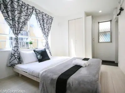 a bedroom with a large bed and a window at Easy Access to Skytree Studio Bell Flat Inn #4 in Tokyo