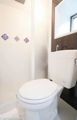 a white bathroom with a toilet and a mirror at Easy Access to Skytree Studio Bell Flat Inn #4 in Tokyo
