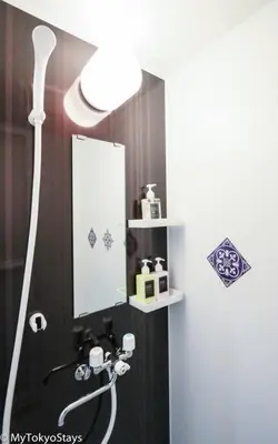 a bathroom with a shower with a mirror and a sink at Easy Access to Skytree Studio Bell Flat Inn #4 in Tokyo