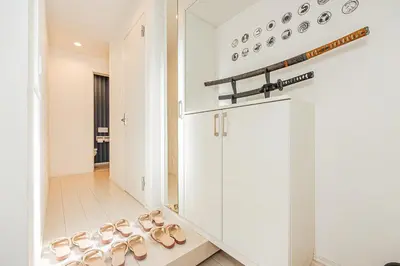 a room with a row of pairs of shoes at SkyTreeStayHotel2\u9418\u30f6\u6df5\u99c5\u304b\u3089\u5f92\u6b694\u5206\u5929\u4e95\u304b\u3089skytree\u304c\u898b\u3048\u307e\u3059 in Tokyo