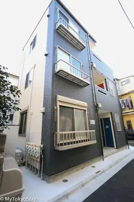 a blue building with two balconies on a street at Easy Access to Skytree 1BR Bell Flat Inn #5 in Tokyo