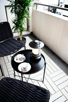 a black table with two plates on it on a patio at #6 stylish apartment with beautiful night view A stop to Shinjuku station in Tokyo