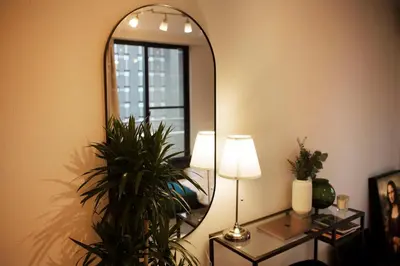 a room with a mirror and a lamp and plants at #6 stylish apartment with beautiful night view A stop to Shinjuku station in Tokyo