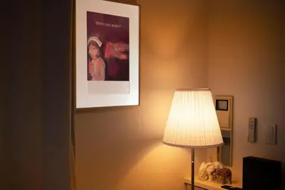 a lamp in a room with a picture on the wall at #6 stylish apartment with beautiful night view A stop to Shinjuku station in Tokyo