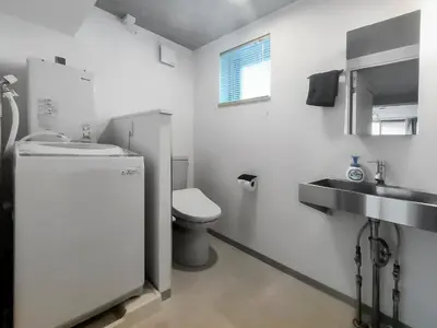 a white bathroom with a toilet and a sink at SaffronCasa Asakusabashi by Tranova in Tokyo