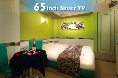a small room with a bed with a table in it at Hotel Will\u6c60\u888b Adult Only in Tokyo