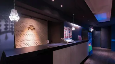 a restaurant with a counter with a sign on the wall at Hotel Will\u6c60\u888b Adult Only in Tokyo