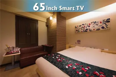 a hotel room with a bed and a couch at Hotel Will\u6c60\u888b Adult Only in Tokyo