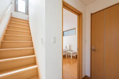 a staircase in a house with a wooden door at \u65b0\u5bbf \u6b4c\u821e\u4f0e\u753a\u3059\u3050 \u8cb8\u5207\u4e00\u8ed2\u5bb6 \u6771\u65b0\u5bbf2\u5206 \u6700\u59278\u540d \u5168\u5ba4\u30a8\u30a2\u30b3\u30f3 \u30ad\u30c3\u30c1\u30f3\u8a2d\u5099\u5b8c\u5099 in Tokyo