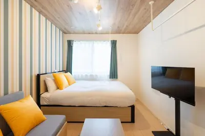 a small bedroom with a bed and a tv at MAT OSHIAGE Ⅱ in Tokyo
