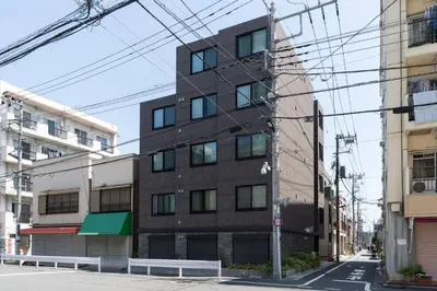 a tall brown building on a city street at MAT OSHIAGE Ⅱ in Tokyo
