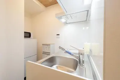 a kitchen with a sink and a refrigerator at MAT OSHIAGE Ⅱ in Tokyo