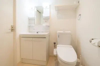 a white bathroom with a toilet and a sink at MAT OSHIAGE Ⅱ in Tokyo