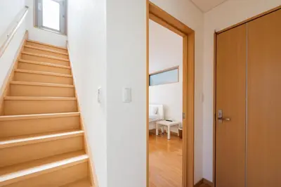 a staircase in a home with white walls and wooden floors at Fukuhama - Vacation STAY 13867 in Tokyo