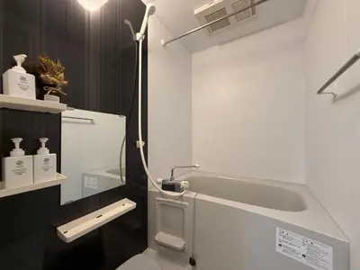 a white bathroom with a toilet and a sink at nestay inn tokyo asakusa in Tokyo