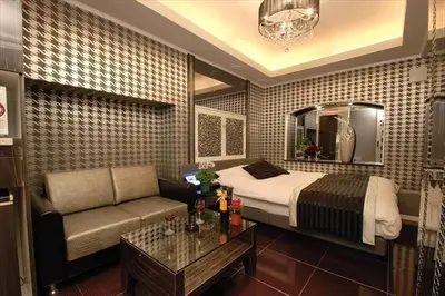 a hotel room with a bed and a couch at HOTEL Shuffle in Tokyo