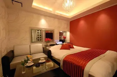 a hotel room with a bed and a couch at HOTEL Shuffle in Tokyo
