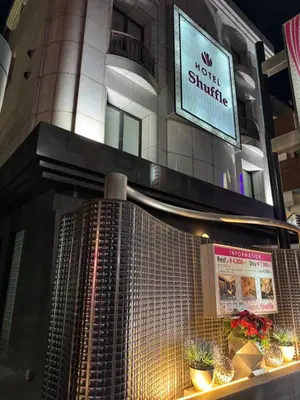 a building with a sign that reads no guest struggle at HOTEL Shuffle in Tokyo